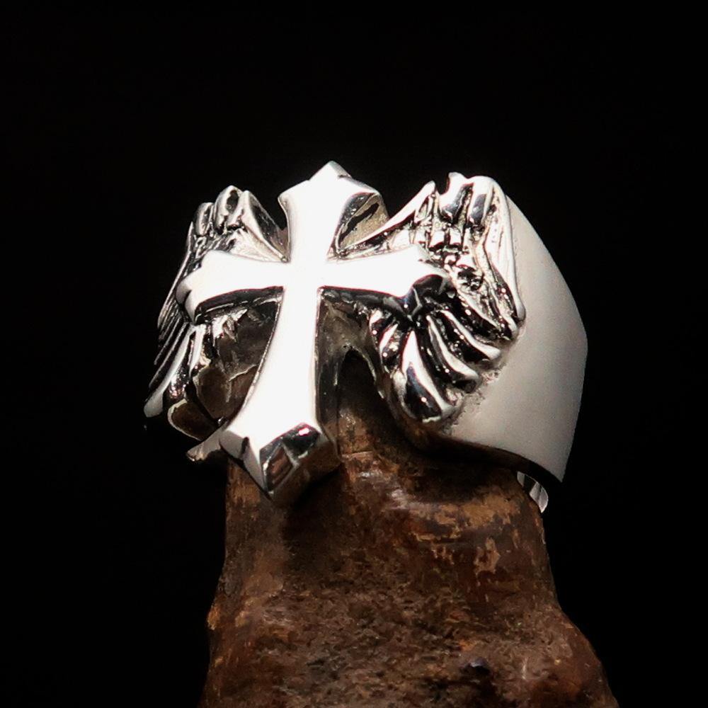 Antiqued sterling silver men's winged cross ring with high polish finish, showcasing intricate details and craftsmanship.