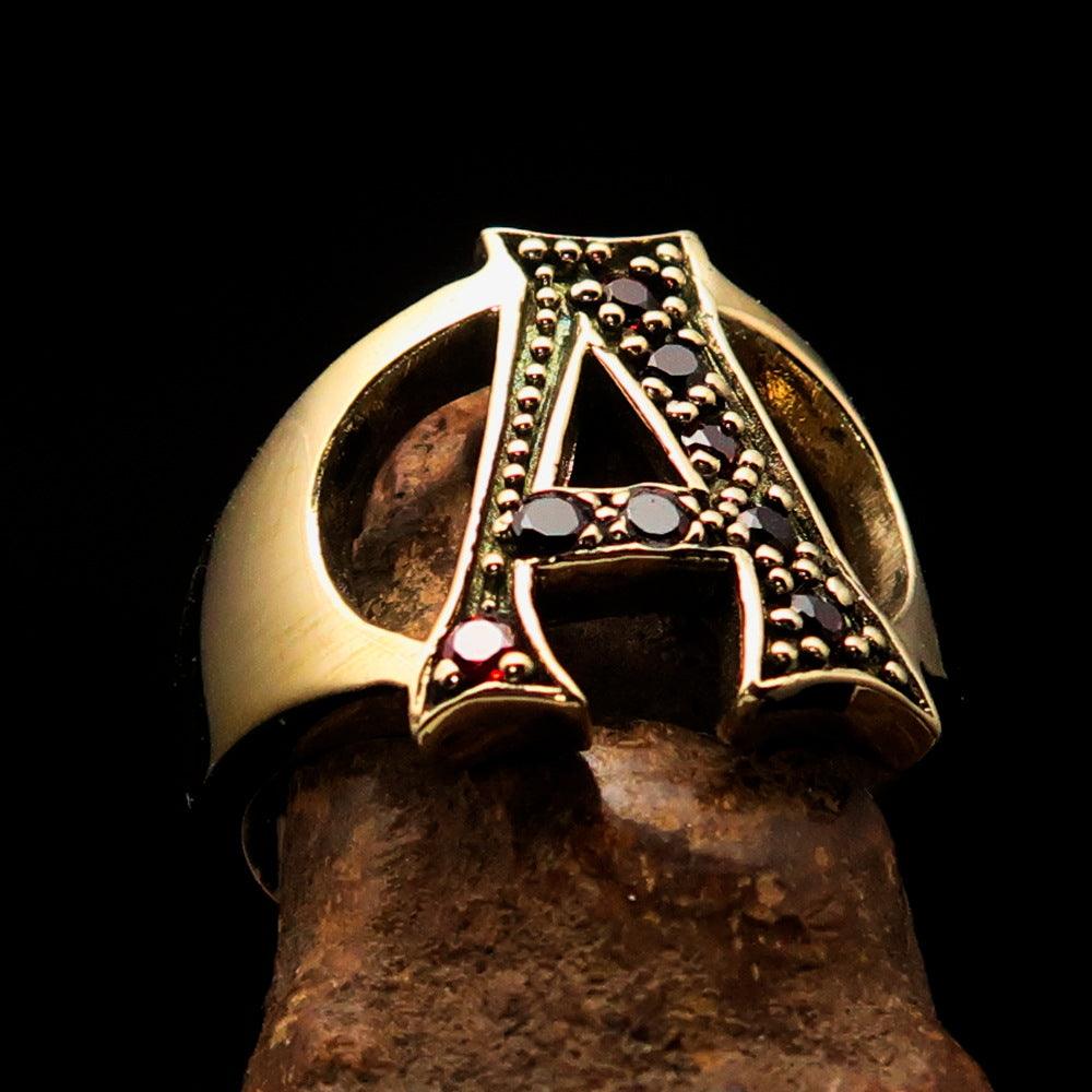 A beautifully crafted Initial Ring featuring a bold letter A, adorned with 8 red Cubic Zirconias, made from solid brass.