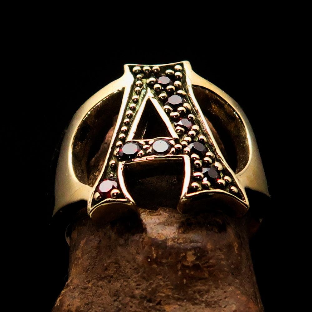 A beautifully crafted Initial Ring featuring a bold letter A, adorned with 8 red Cubic Zirconias, made from solid brass.