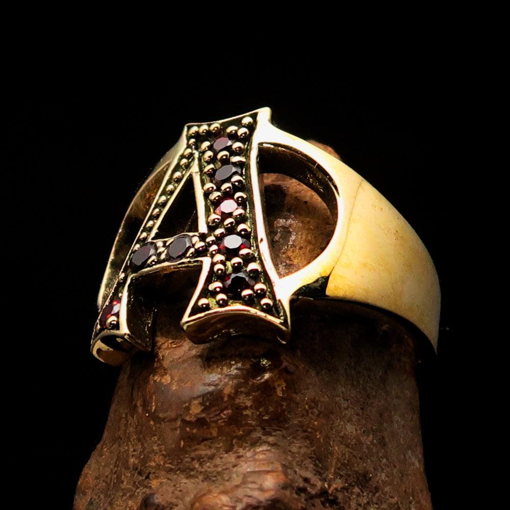 A beautifully crafted Initial Ring featuring a bold letter A, adorned with 8 red Cubic Zirconias, made from solid brass.