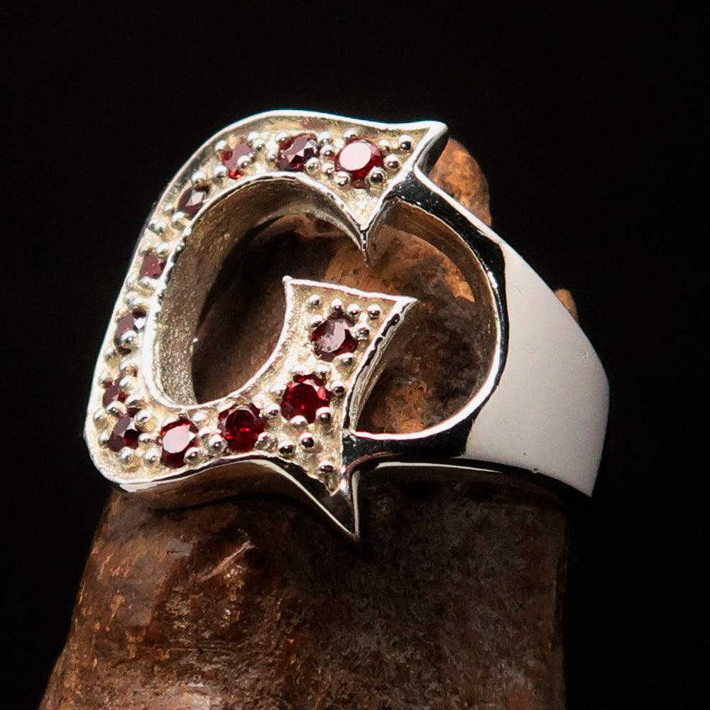 A beautifully crafted sterling silver Initial Ring featuring a bold letter G adorned with 12 vibrant red Cubic Zirconias, showcasing its elegance.