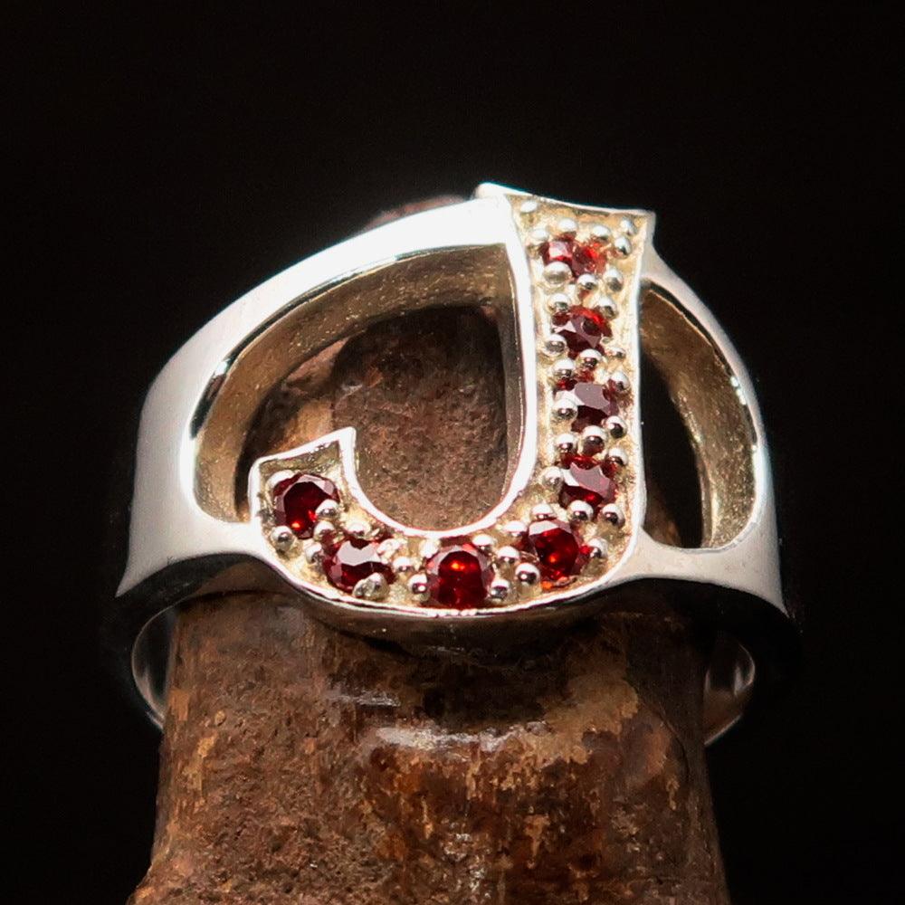 Bold Initial Ring featuring letter J, crafted from sterling silver with 8 red cubic zirconias, showcasing a high polish finish.