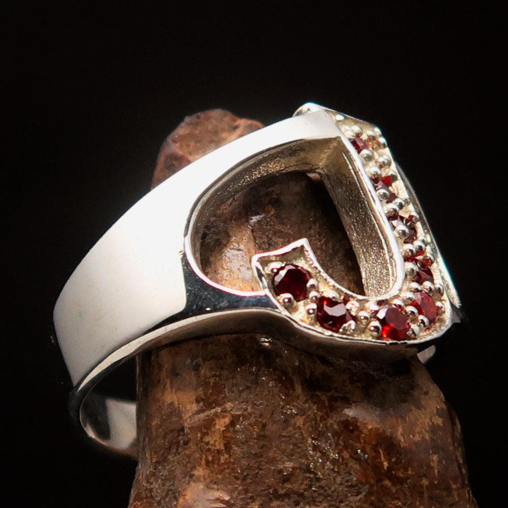 Bold Initial Ring featuring letter J, crafted from sterling silver with 8 red cubic zirconias, showcasing a high polish finish.