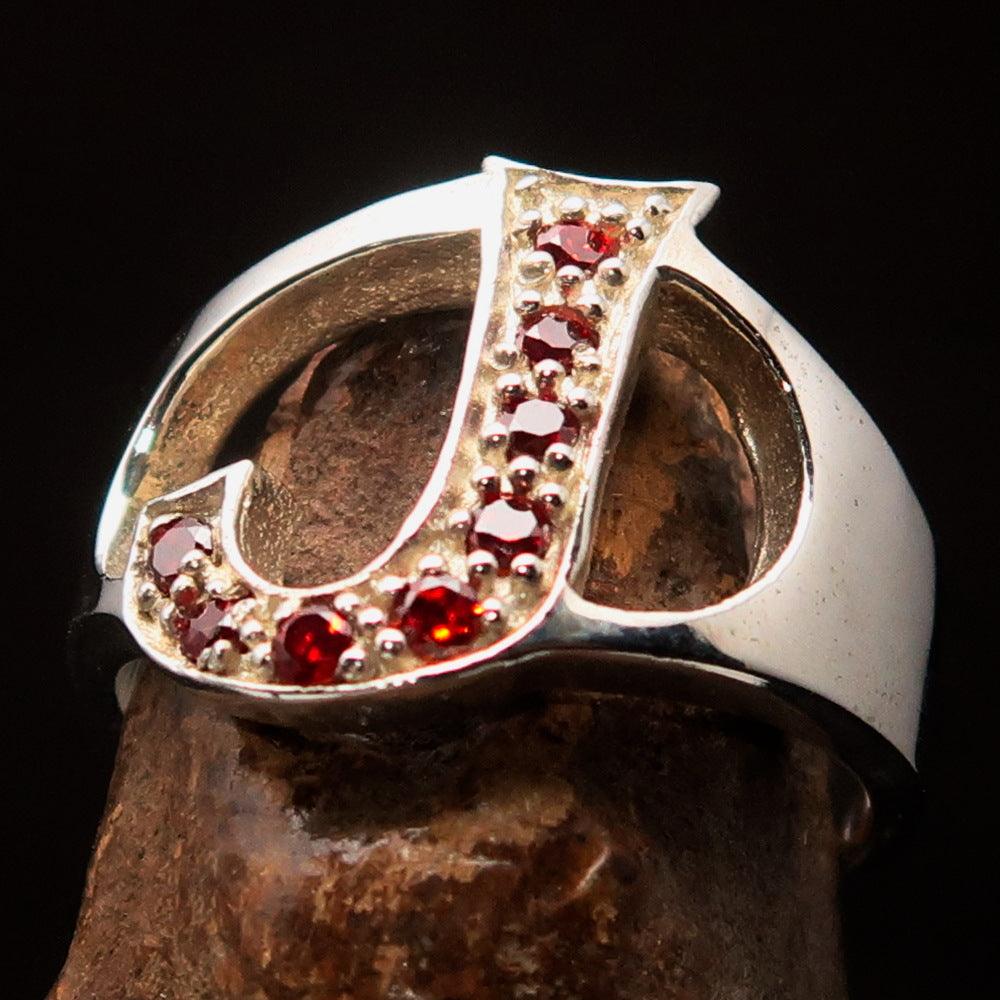 Bold Initial Ring featuring letter J, crafted from sterling silver with 8 red cubic zirconias, showcasing a high polish finish.