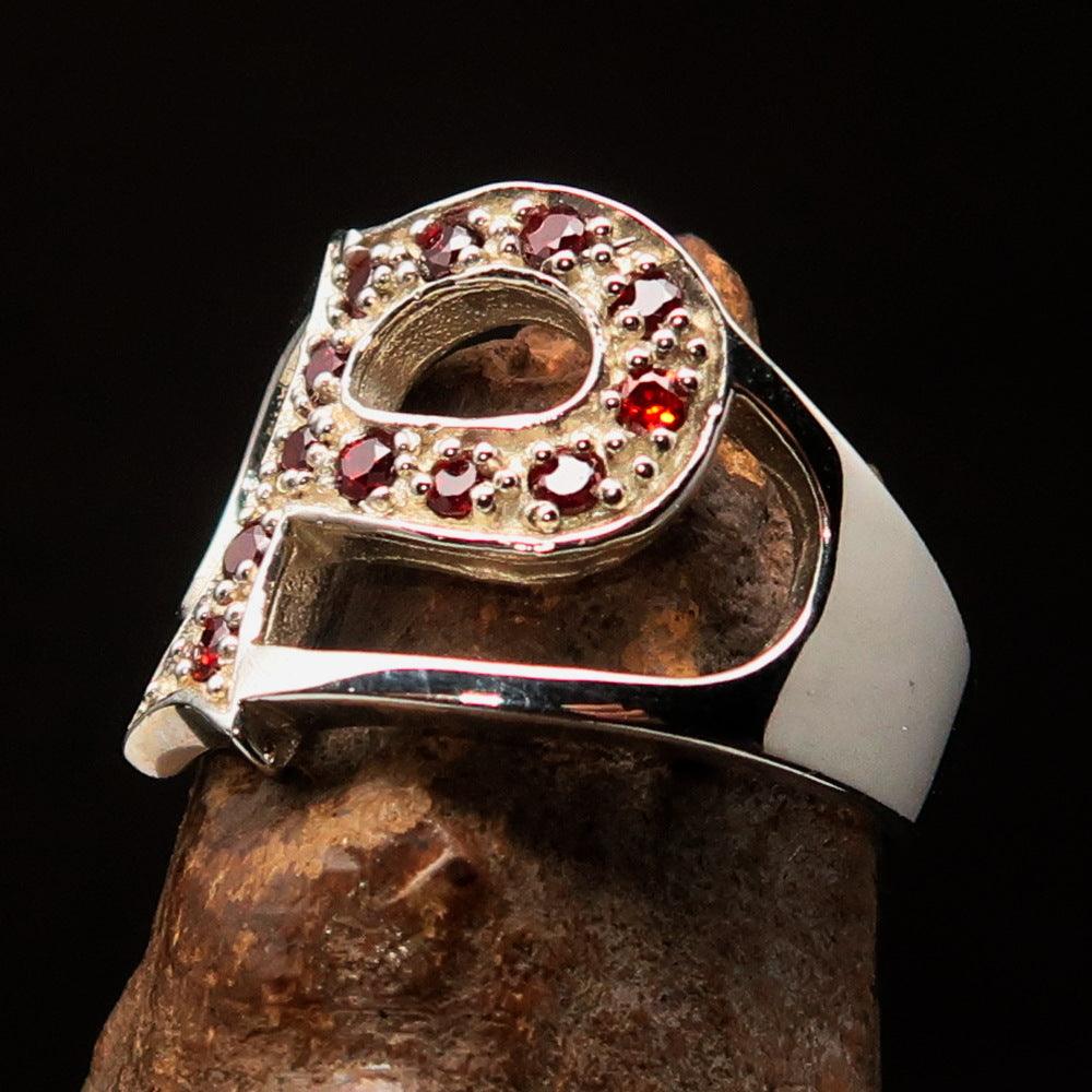 A beautifully crafted sterling silver initial ring featuring a bold letter P, adorned with 12 sparkling red cubic zirconias, showcasing elegance and style.