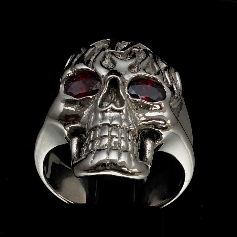 Men's 1% Flaming Skull Outlaw Ring made of solid sterling silver with red cubic zirconia eyes, showcasing a polished finish and detailed skull design.