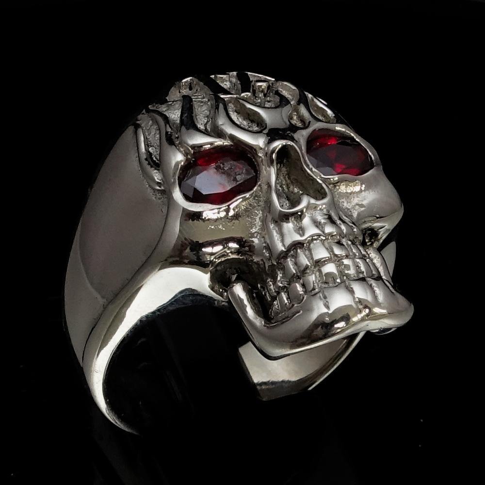 Men's 1% Flaming Skull Outlaw Ring made of solid sterling silver with red cubic zirconia eyes, showcasing a polished finish and detailed skull design.