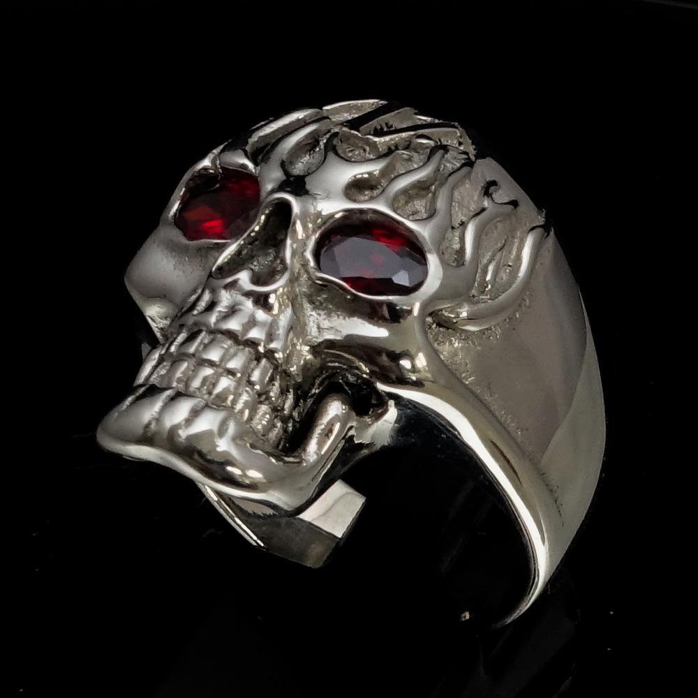 Men's 1% Flaming Skull Outlaw Ring made of solid sterling silver with red cubic zirconia eyes, showcasing a polished finish and detailed skull design.