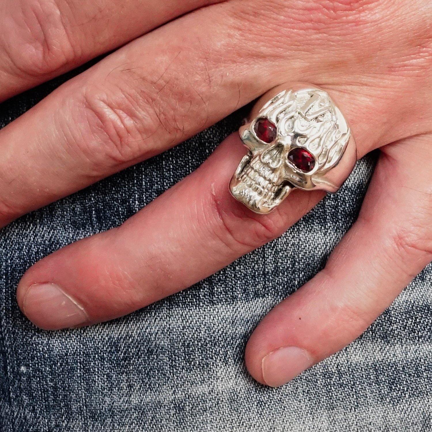 Men's 1% Flaming Skull Outlaw Ring made of solid sterling silver with red cubic zirconia eyes, showcasing a polished finish and detailed skull design.