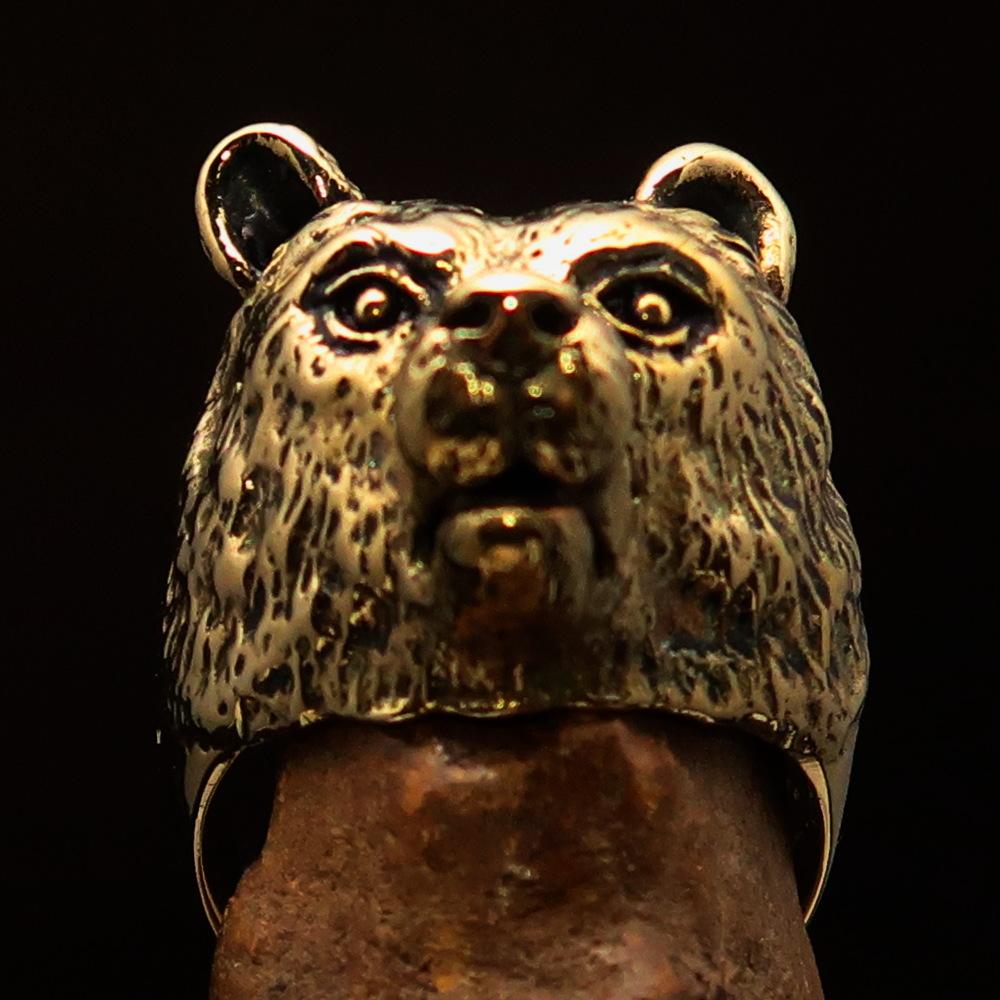 Men's brass animal ranger ring featuring a detailed grizzly bear design, showcasing a high polished and antiqued finish.