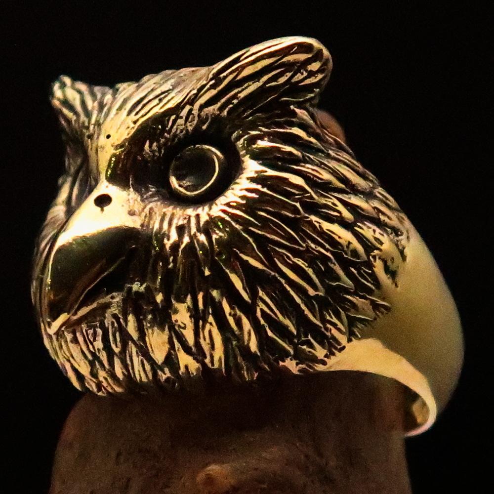 Men's brass ring featuring an intricately designed owl head, showcasing detailed craftsmanship and unique finishes.