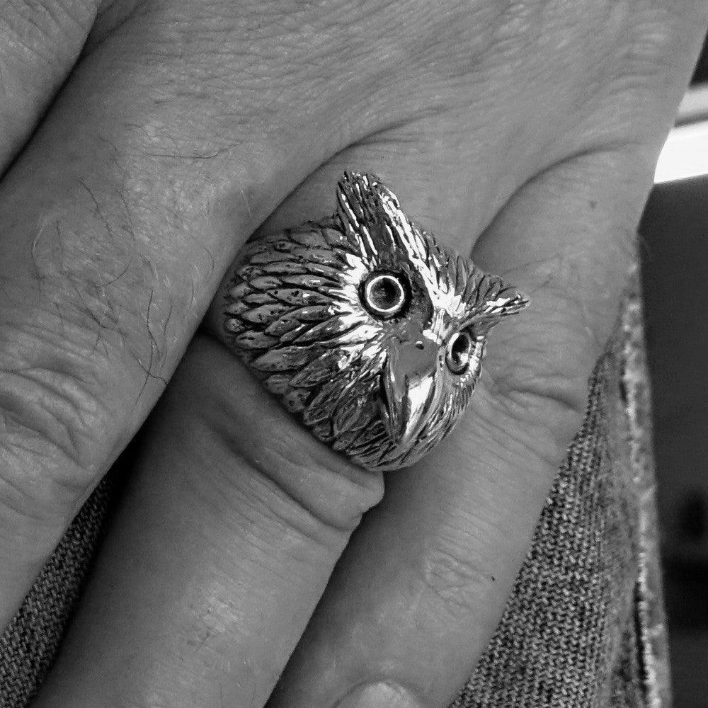 Men's brass ring featuring an intricately designed owl head, showcasing detailed craftsmanship and unique finishes.