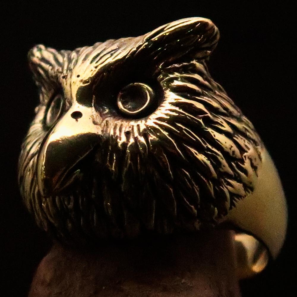 Men's brass ring featuring an intricately designed owl head, showcasing detailed craftsmanship and unique finishes.