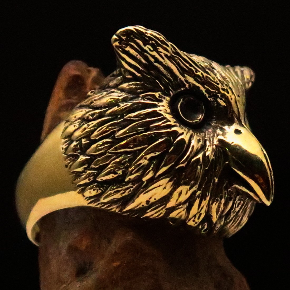 Men's brass ring featuring an intricately designed owl head, showcasing detailed craftsmanship and unique finishes.