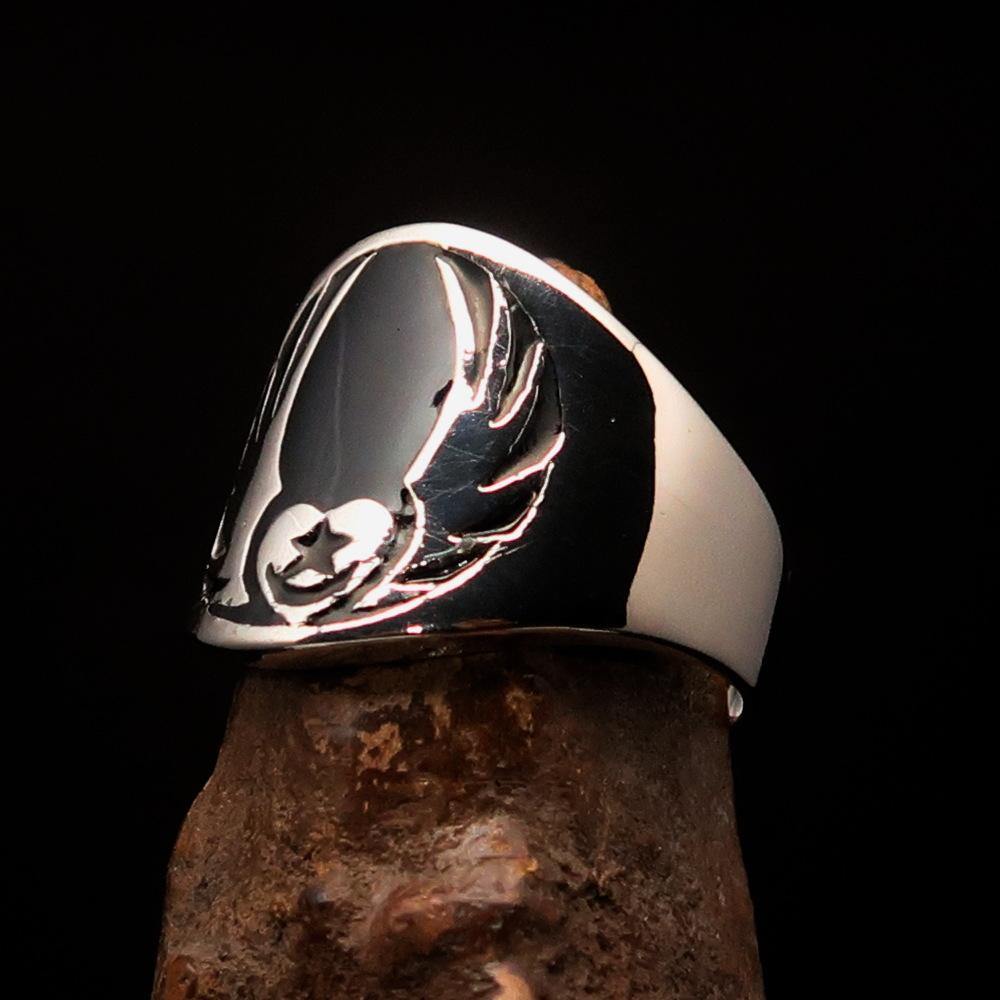 Men's Claddagh Ring featuring a black winged heart design, crafted from solid sterling silver with a high polished finish and enamel accents.