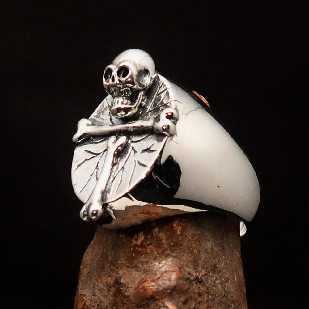 Men's sterling silver ring featuring a bone cross and R.I.P skull design, showcasing intricate craftsmanship and a polished finish.