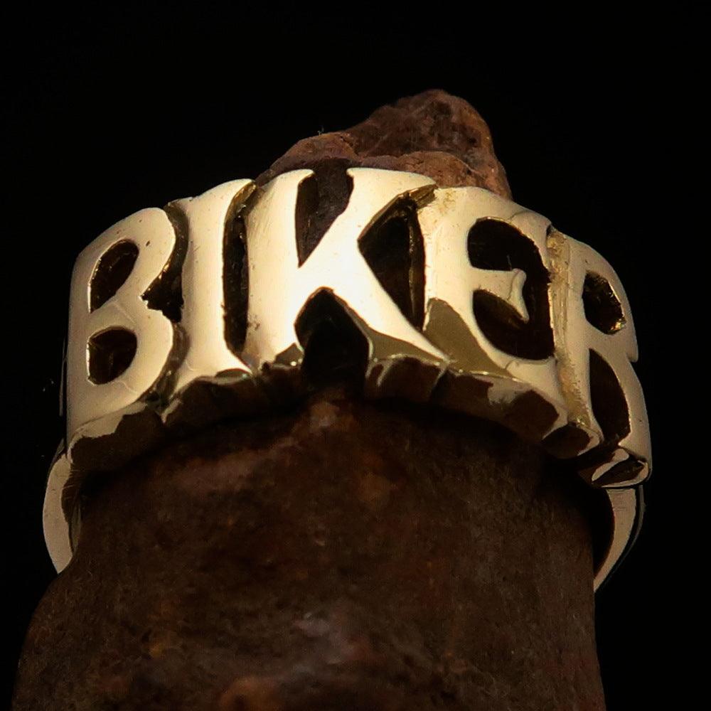 A high-polished solid brass One Word BIKER Ring, showcasing its bold 10 mm width and elegant craftsmanship.