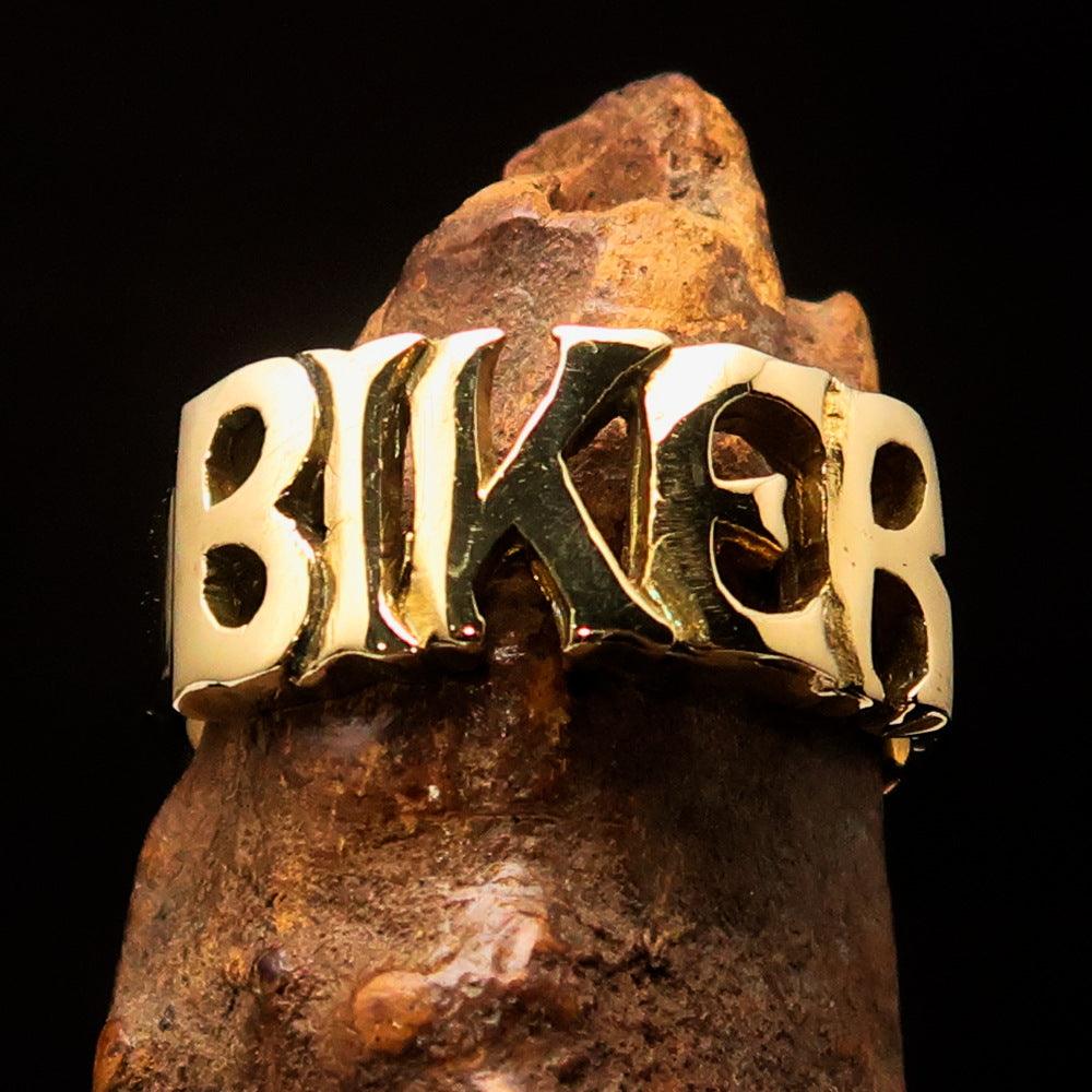 A high-polished solid brass One Word BIKER Ring, showcasing its bold 10 mm width and elegant craftsmanship.