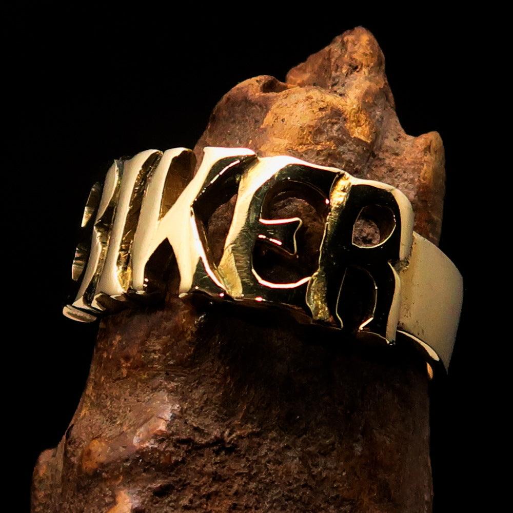 A high-polished solid brass One Word BIKER Ring, showcasing its bold 10 mm width and elegant craftsmanship.