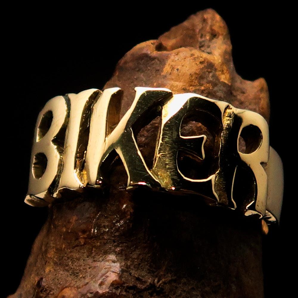 A high-polished solid brass One Word BIKER Ring, showcasing its bold 10 mm width and elegant craftsmanship.