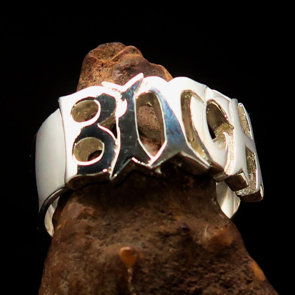 A high-polished sterling silver ring featuring the word 'Bitch', hallmarked 925, showcasing its bold design and craftsmanship.