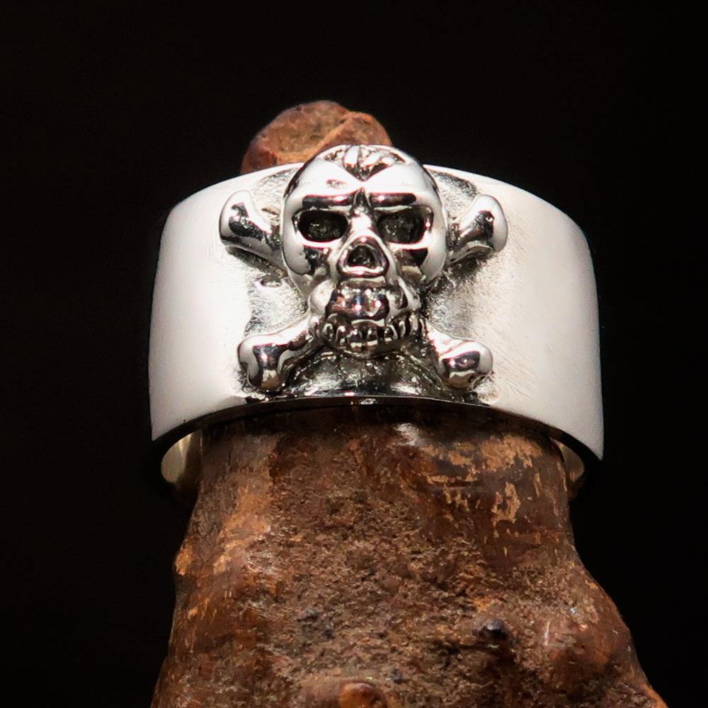 Outlaw 1% Jolly Roger Skull Band Ring made of solid sterling silver with an antiqued finish and polished details.