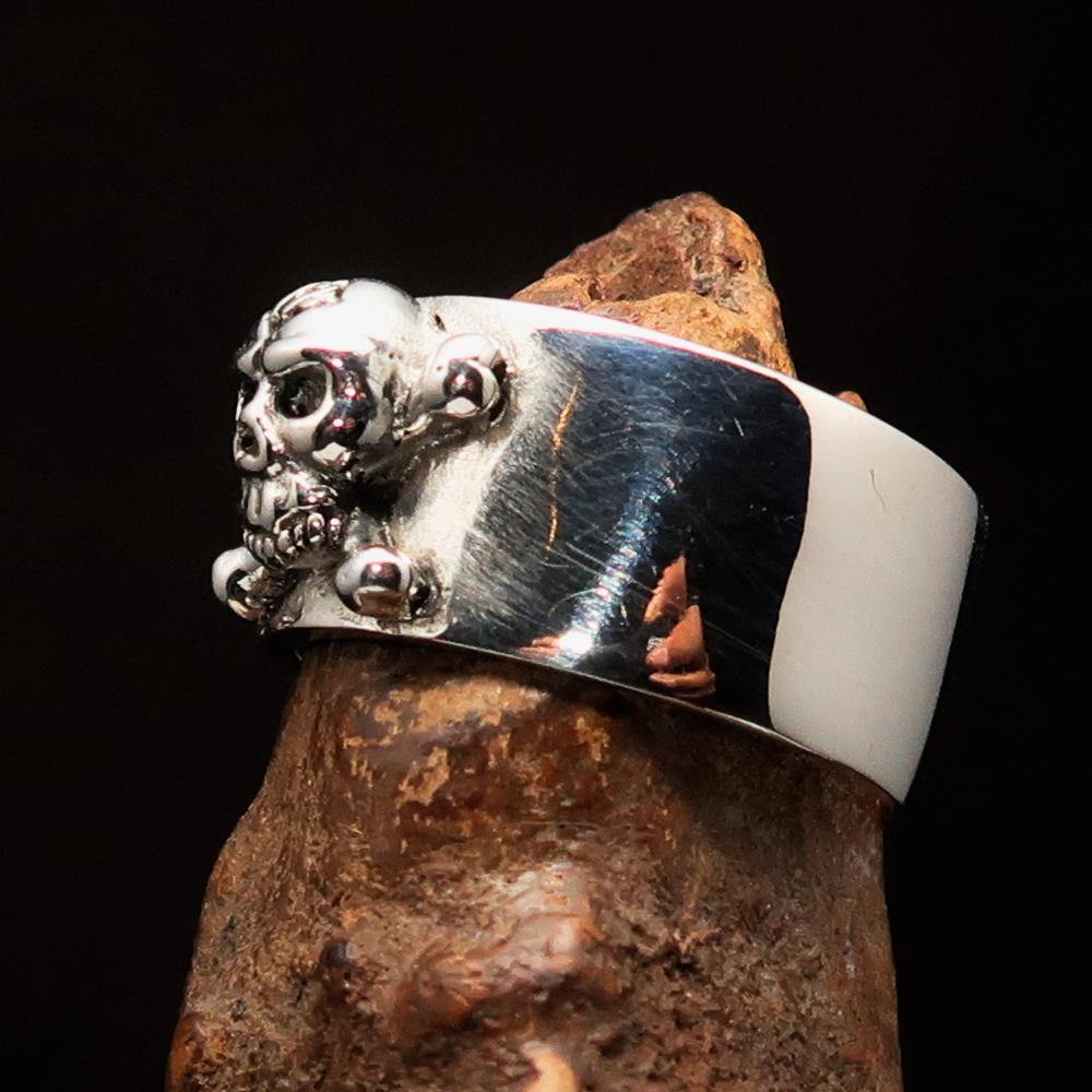 Outlaw 1% Jolly Roger Skull Band Ring made of solid sterling silver with an antiqued finish and polished details.