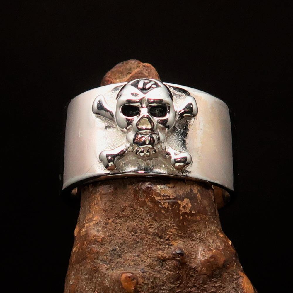 Outlaw black 1% Jolly Roger Skull Band Ring made of solid sterling silver with black enamel finish, showcasing a bold skull design.