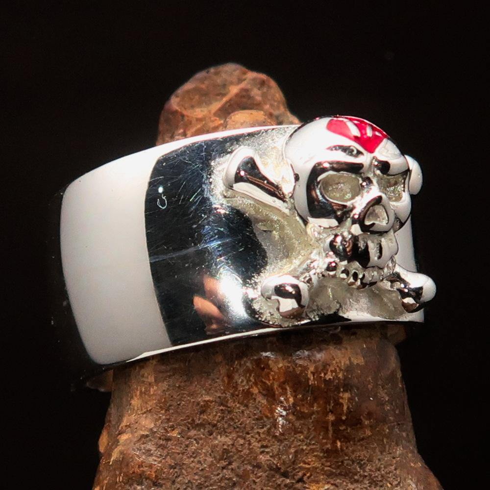 Outlaw red 1% Jolly Roger Skull Band Ring made of sterling silver with red enamel detailing, showcasing a polished finish.