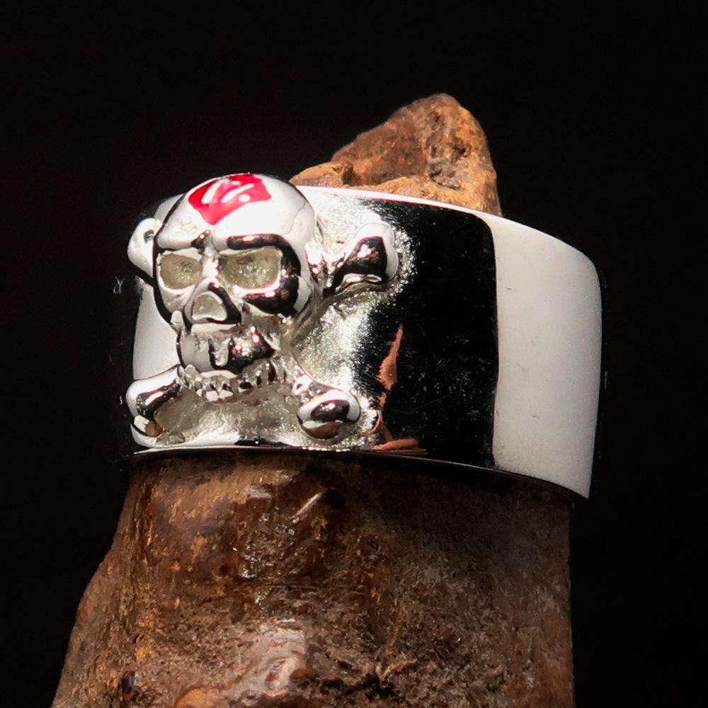 Outlaw red 1% Jolly Roger Skull Band Ring made of sterling silver with red enamel detailing, showcasing a polished finish.