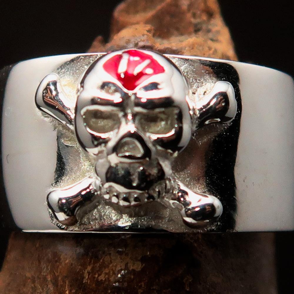 Outlaw red 1% Jolly Roger Skull Band Ring made of sterling silver with red enamel detailing, showcasing a polished finish.