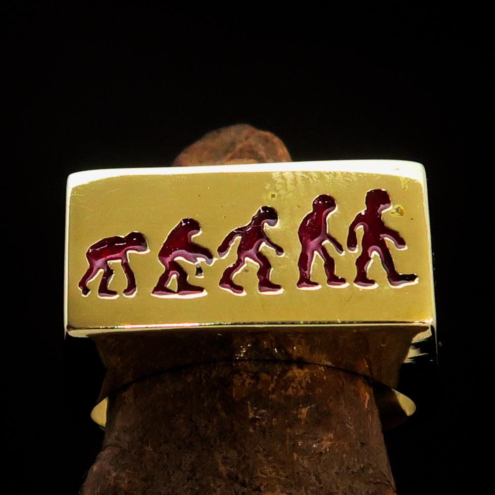 Rectangle-shaped red Human Evolution Ring made of solid brass with high-polished finish and red enamel.