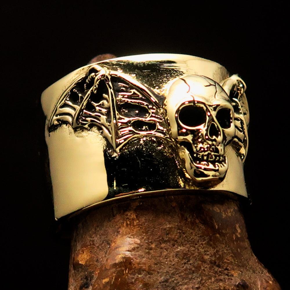 A beautifully crafted winged Bat Skull Ring made of antiqued brass, featuring intricate details on the bat skull and wings.