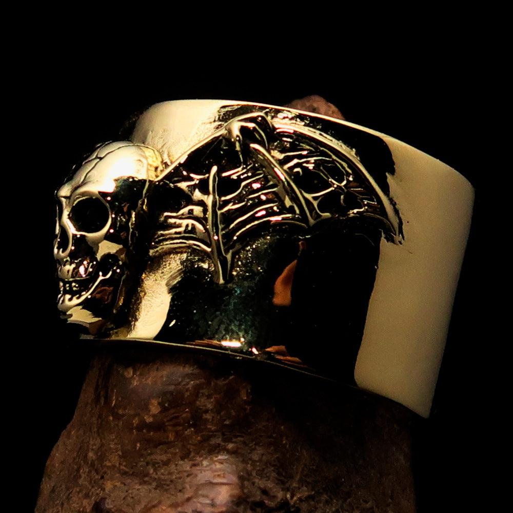 A beautifully crafted winged Bat Skull Ring made of antiqued brass, featuring intricate details on the bat skull and wings.