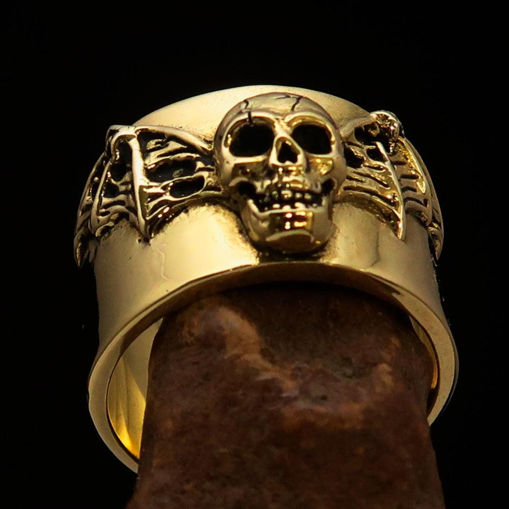 A beautifully crafted winged Bat Skull Ring made of antiqued brass, featuring intricate details on the bat skull and wings.