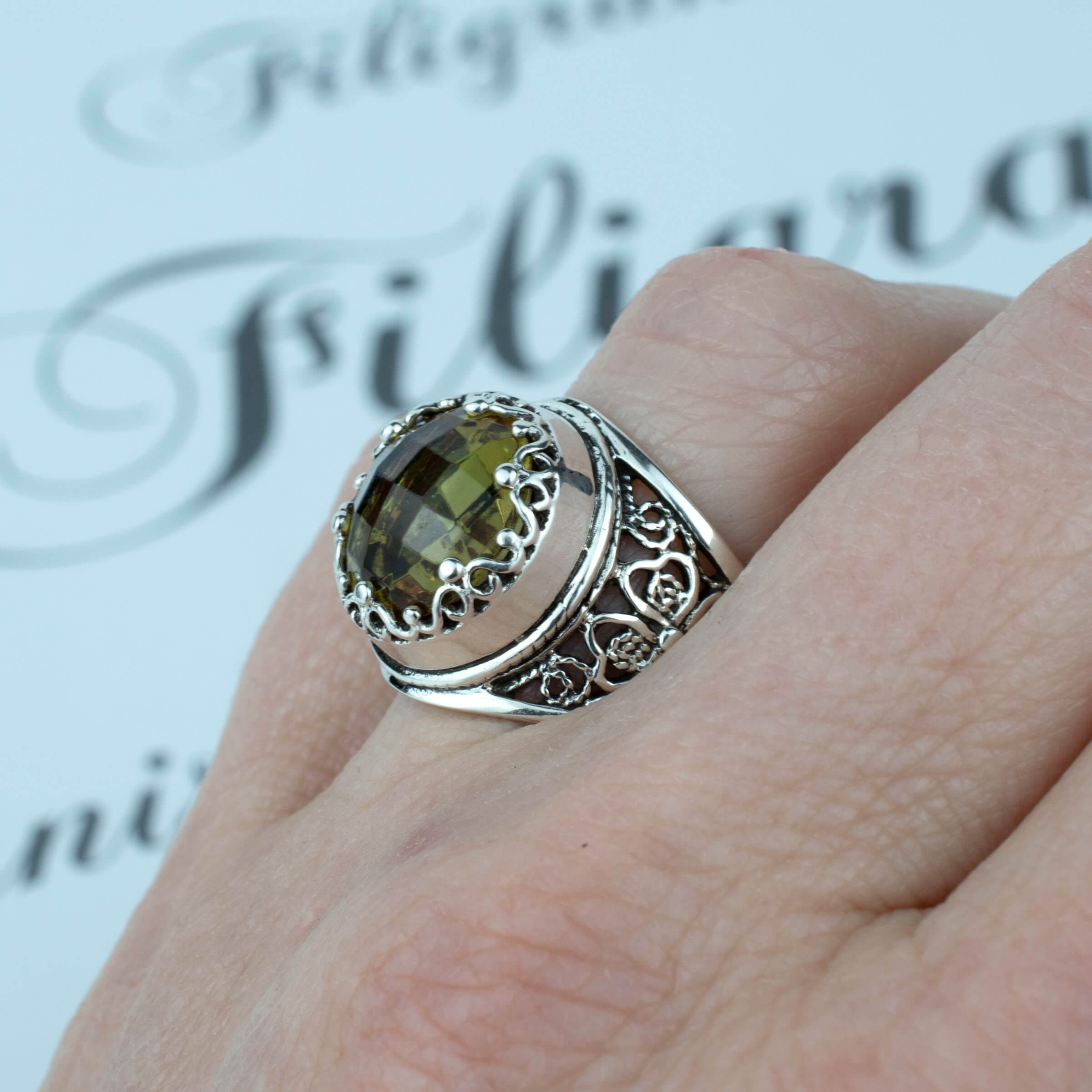 A stunning sterling silver statement ring featuring a lab-created Alexandrite gemstone in a delicate filigree design.