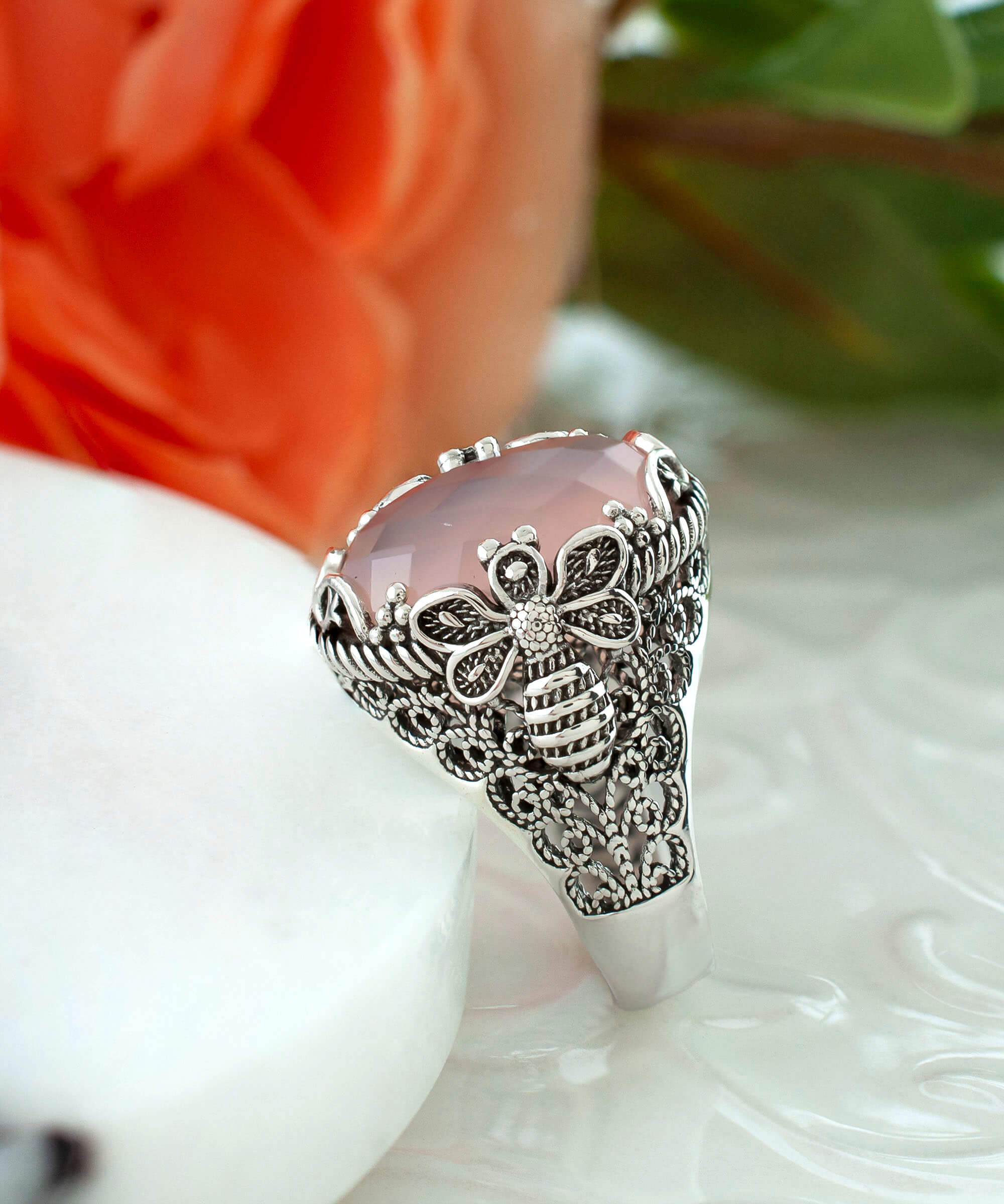 Elegant 925 sterling silver ring featuring a pink chalcedony gemstone with intricate filigree art bee detailing.