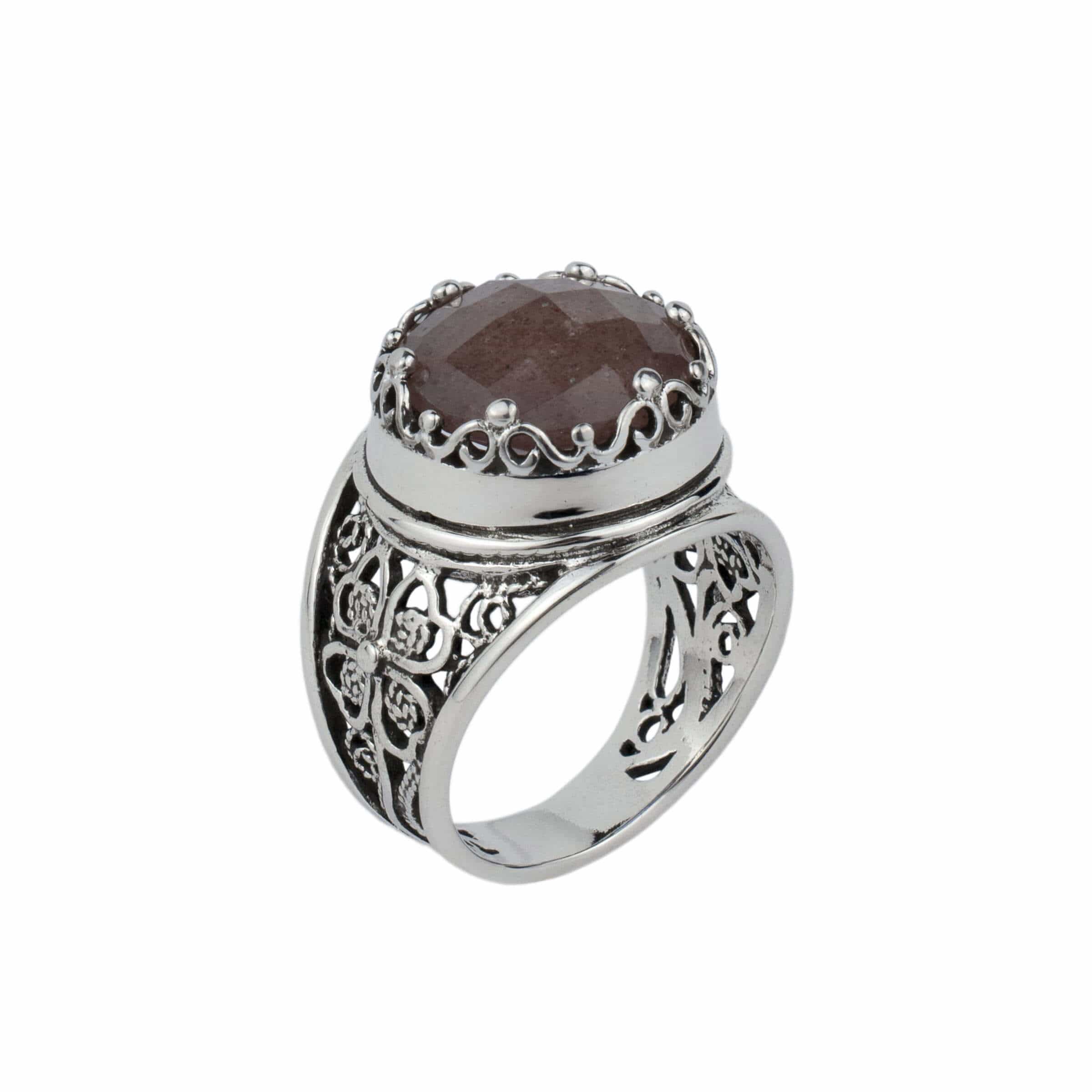 A stunning sterling silver filigree ring featuring a 12mm cherry quartz gemstone, elegantly designed with intricate metalwork.