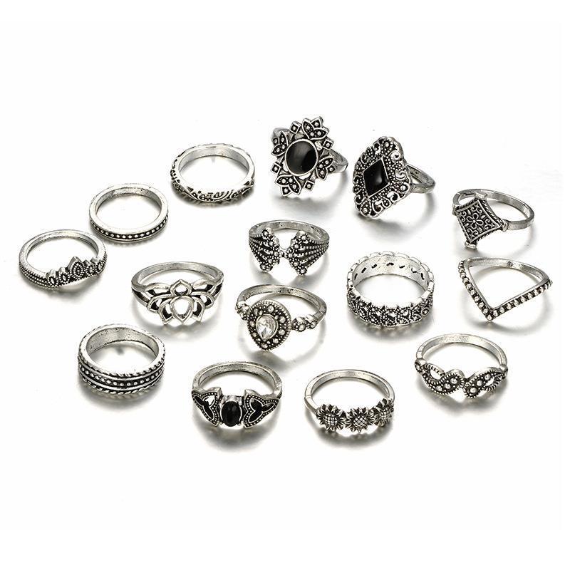 A beautiful set of 15 flower rings made from zinc alloy and crystal, showcasing intricate designs and sparkling details.