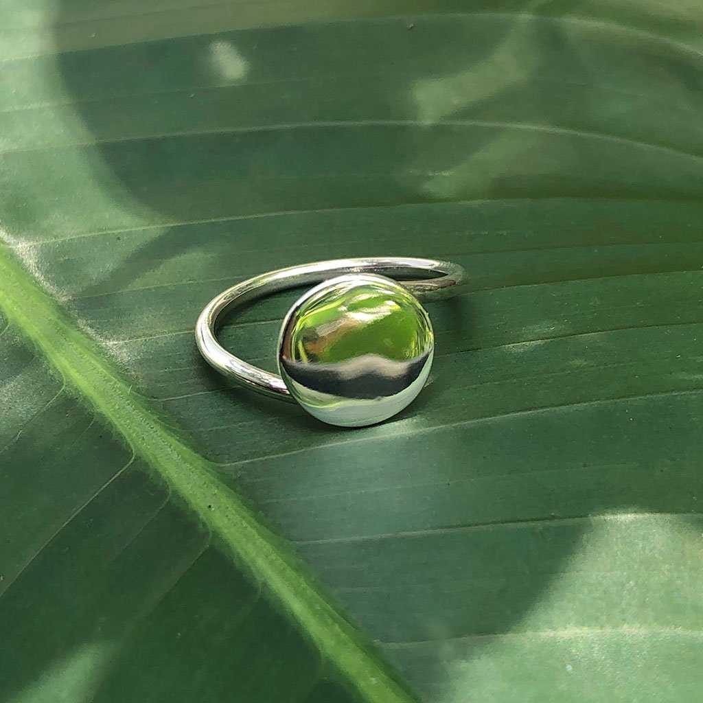 A minimalist Full Moon Ring made of sterling silver, showcasing a smooth, round design that reflects the beauty of the moon.