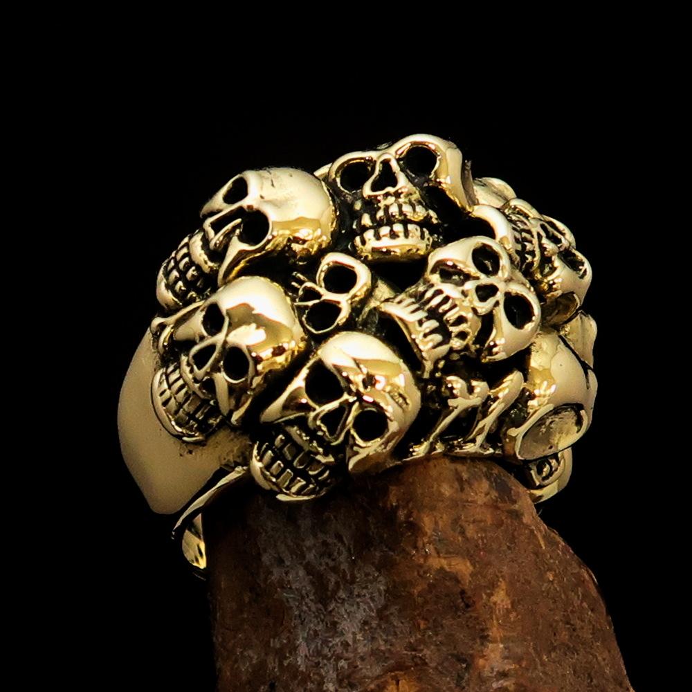 Men's Brass Costume Biker Ring featuring 13 detailed skulls with a high polished and antiqued finish, perfect for graveyard parties.