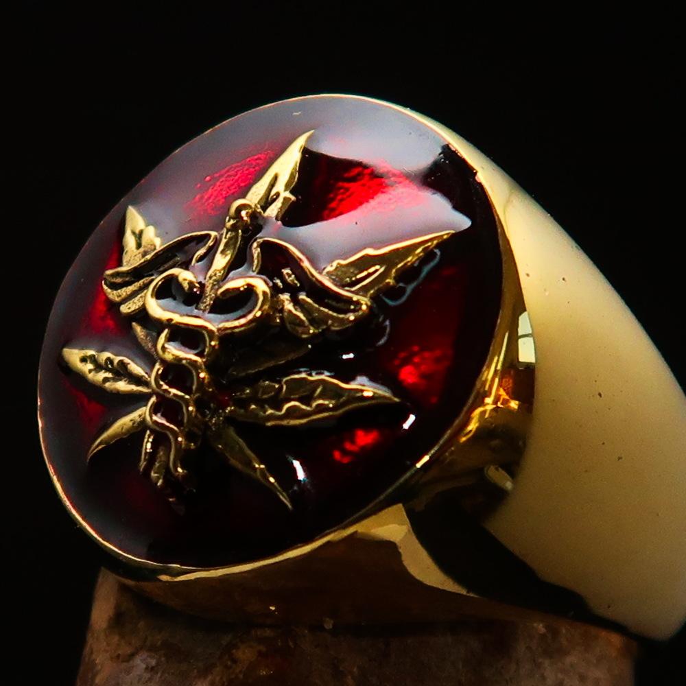 Men's solid brass ring featuring a cannabis leaf design with red enamel finish, symbolizing marijuana culture.