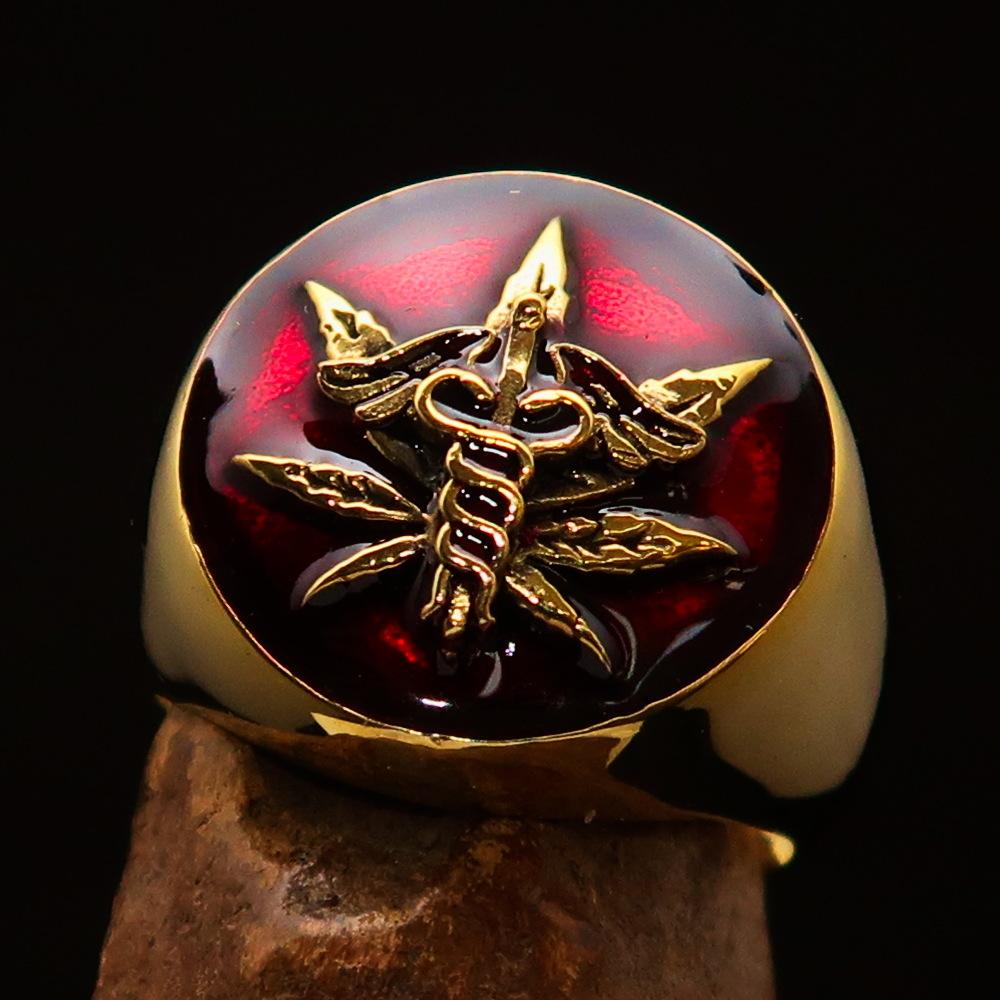 Men's solid brass ring featuring a cannabis leaf design with red enamel finish, symbolizing marijuana culture.