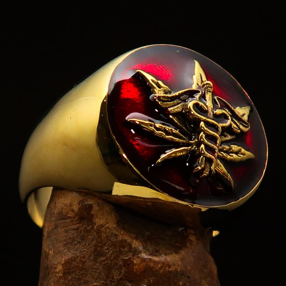 Men's solid brass ring featuring a cannabis leaf design with red enamel finish, symbolizing marijuana culture.