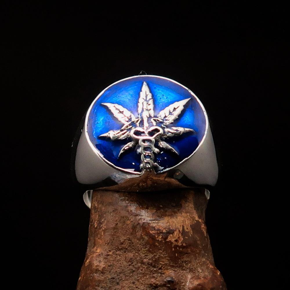 Men's sterling silver ring featuring a cannabis leaf symbol with blue enamel, showcasing a polished finish and unique design.