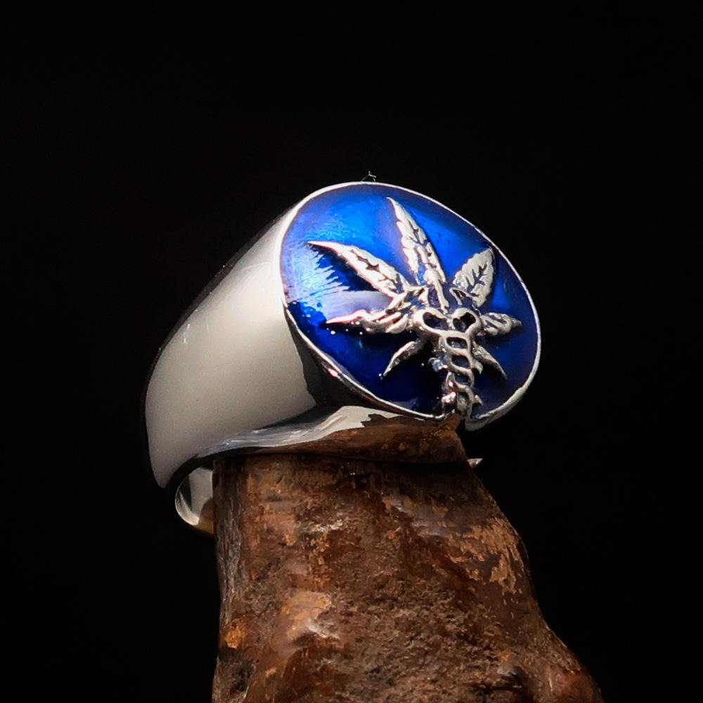 Men's sterling silver ring featuring a cannabis leaf symbol with blue enamel, showcasing a polished finish and unique design.