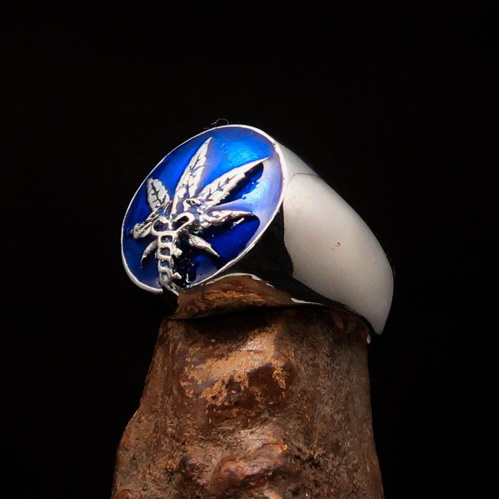 Men's sterling silver ring featuring a cannabis leaf symbol with blue enamel, showcasing a polished finish and unique design.