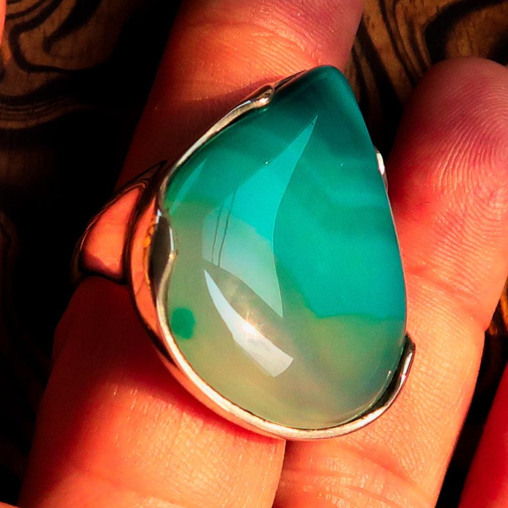 Minimalistic sterling silver ring featuring a pear-shaped green Agate cabochon, polished to a mirror finish.