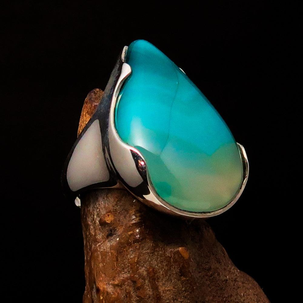 Minimalistic sterling silver ring featuring a pear-shaped green Agate cabochon, polished to a mirror finish.