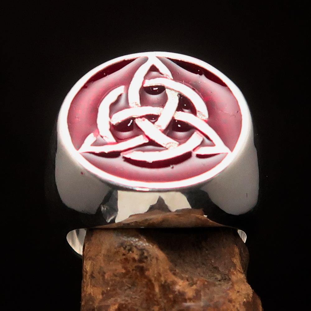 Men's Triquetra Ring featuring a Celtic Triskelion Knot design in solid sterling silver with red enamel accents, showcasing intricate craftsmanship.